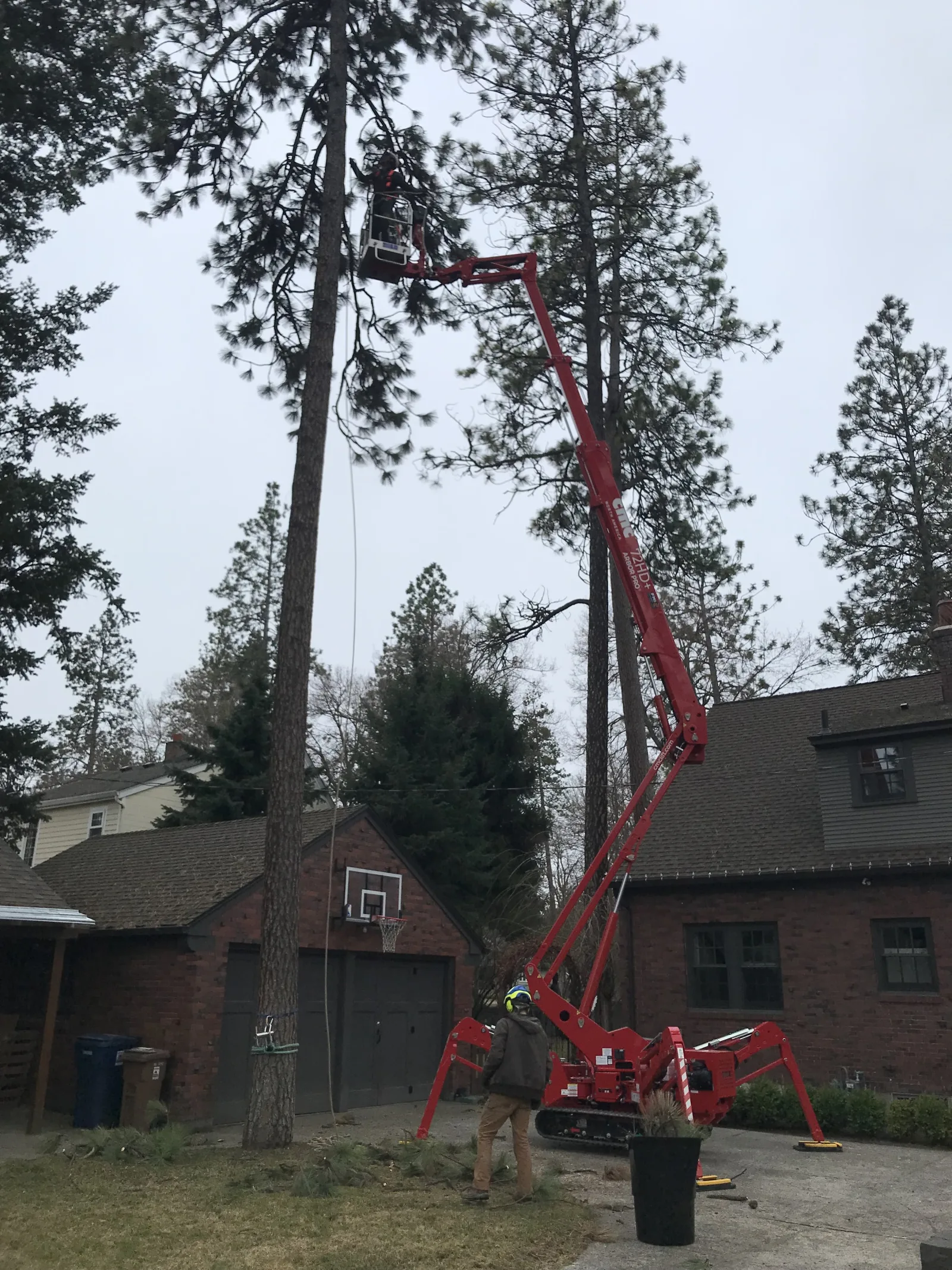 Trailhead Tree Service's 72-foot spider lift set up beside a Spokane home