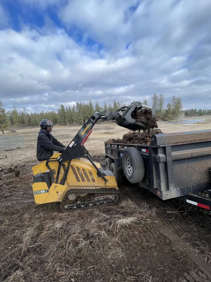 Trailhead mini skid-steer loading debris on a Spokane job site